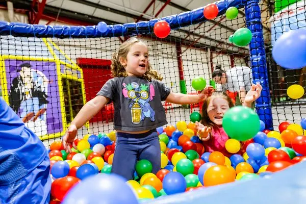 Children throwing balls in the ball pit