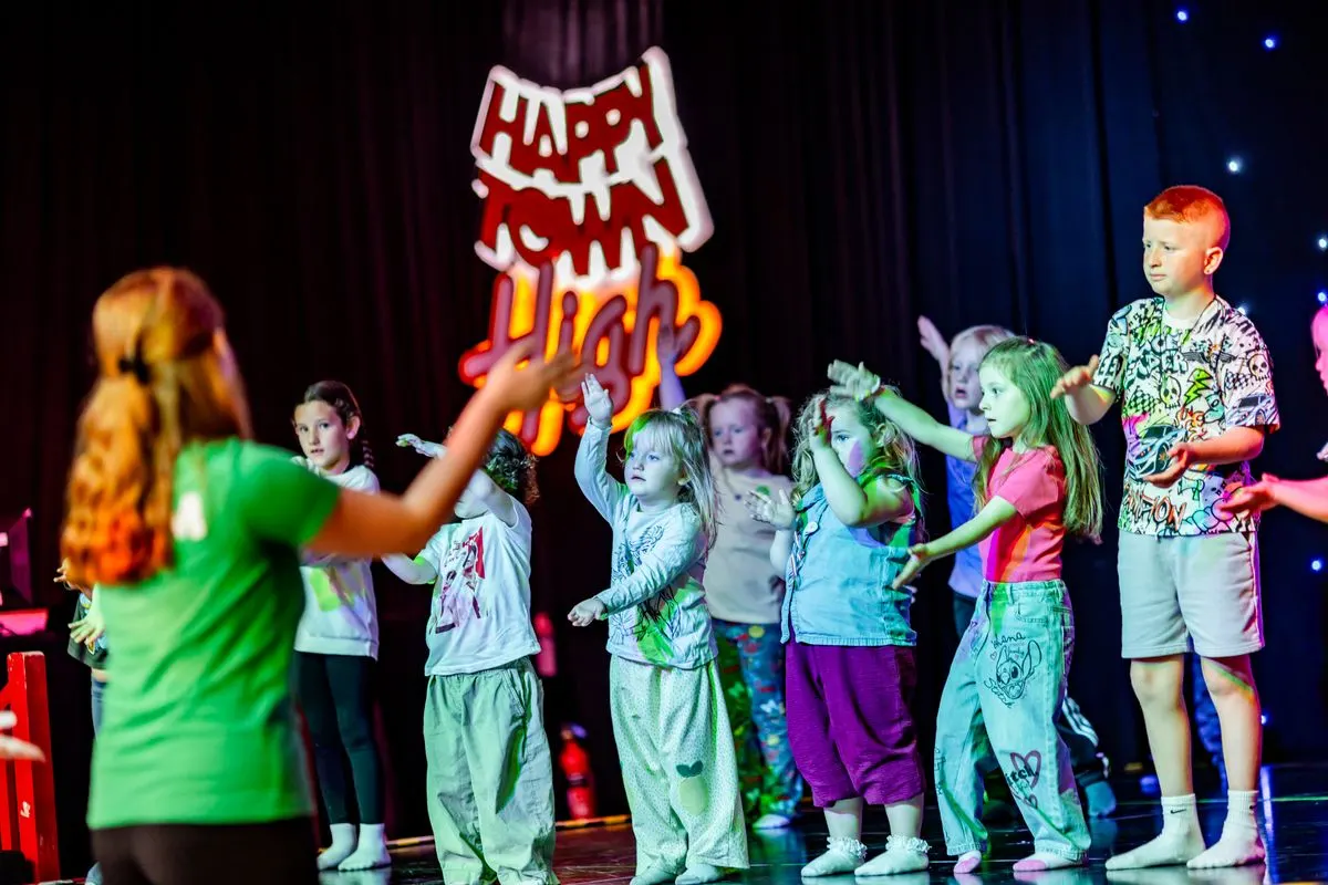 Children performing on the Happy Town High stage
