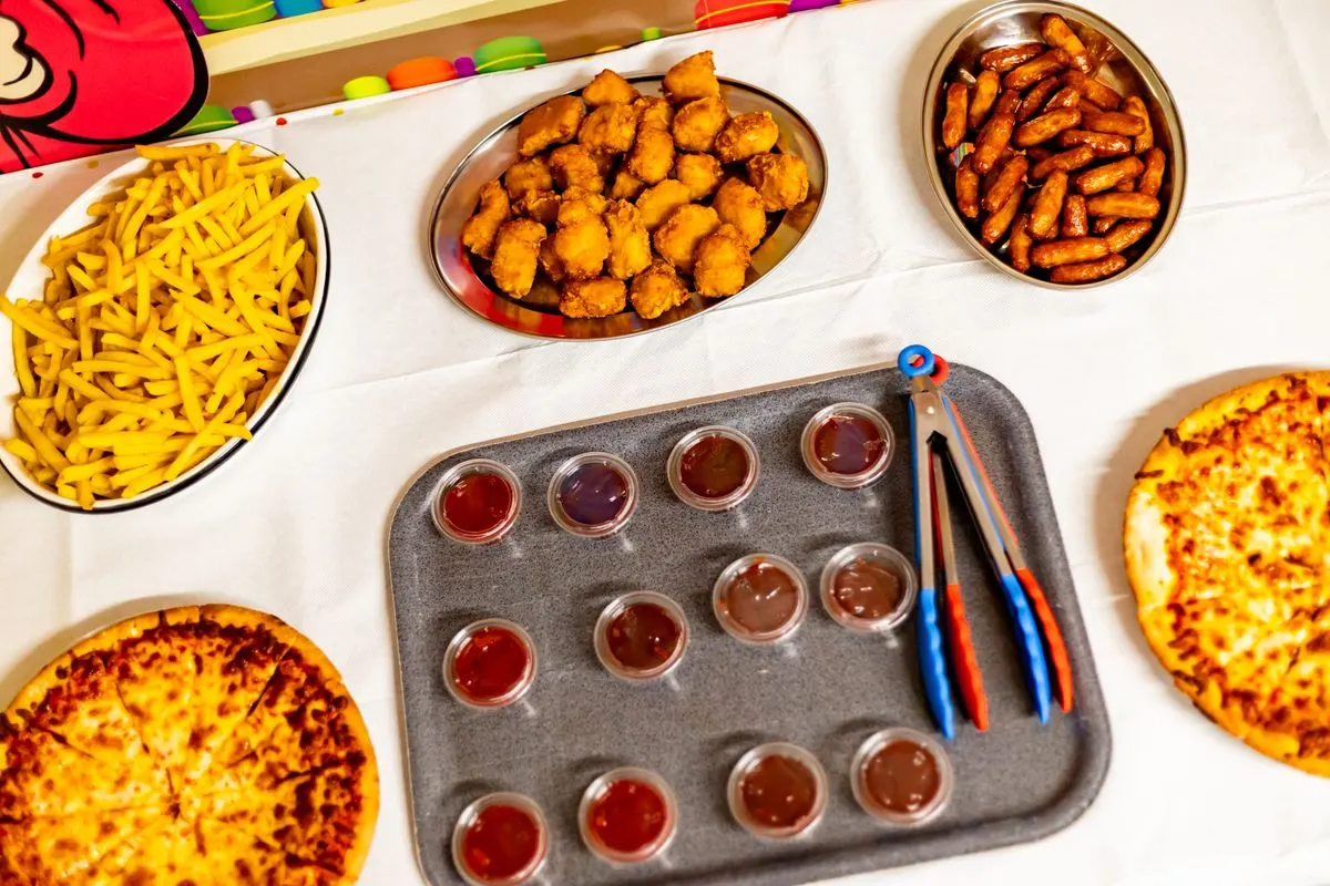 Party food: pizza, chips, nuggets, sausages and dips