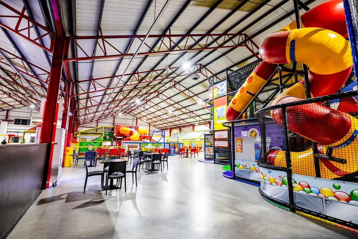Inside Happy Town, with the play frames beside the café seating